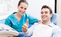Smiling patient in dentist chair