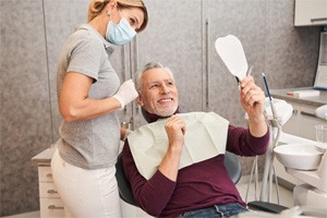 man talking to dentist about cost of veneers in Greenfield 