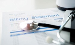 a medical billing statement with a stethoscope laying on top of it 