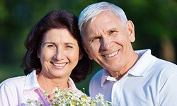 Senior man and woman smiling together outdoors