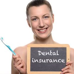 woman holding dental insurance sign