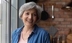 Woman smiling by a window