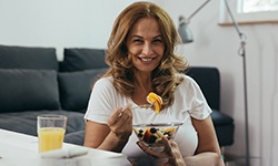 Woman eating a fruit salad