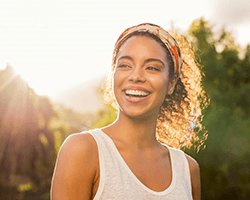 a woman in Greenfield smiling while enjoying time outside