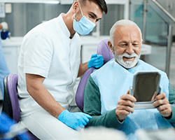 a patient smiling after receiving his dentures in Greenfield