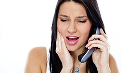 Woman calling her Greenfield emergency dentist 