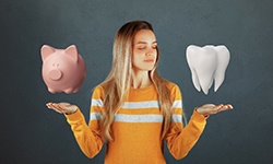 Piggy bank and tooth hovering over woman’s hands