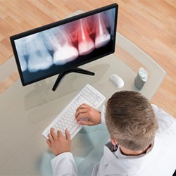 A dentist examining an X-ray.