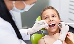 A young child having her dental exam.