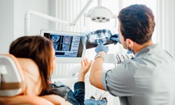 a dentist showing a patient their X-rays