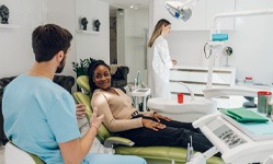 a dentist speaking with a patient