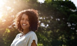 a smiling woman outside