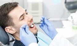 Man visiting emergency dentist in Greenfield for an exam