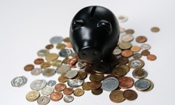 Black piggy bank and coins