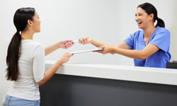 Patient in Greenfield filling out forms for teeth whitening