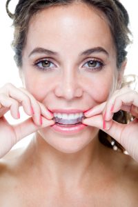 Your dentist in Greenfield looks at the benefits and differences between Invisalign and Six Month Smiles.