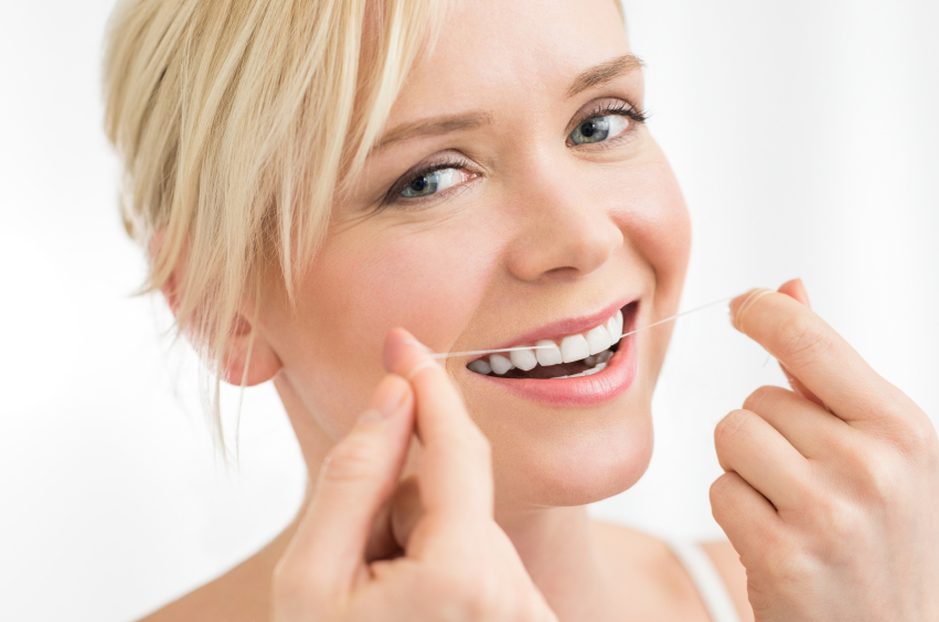 Woman smiling while flossing