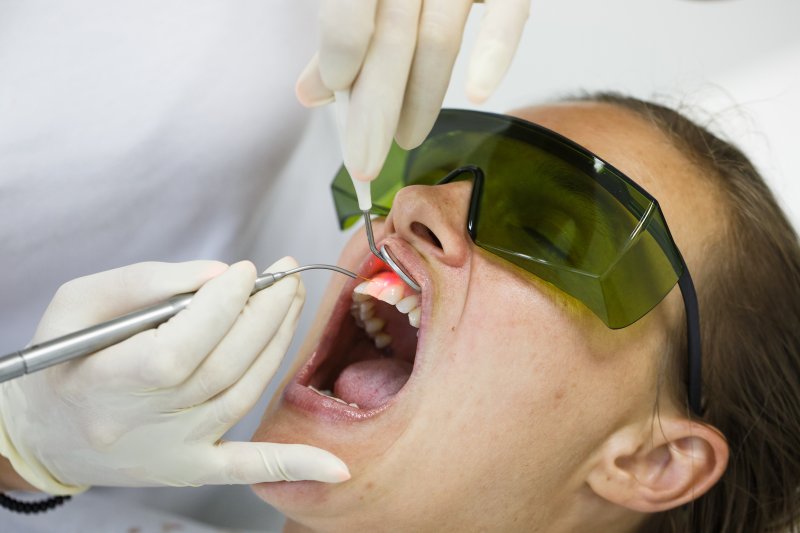 A woman receiving laser dentistry.