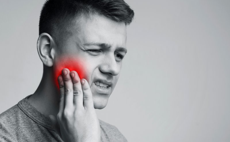 a person experiencing tooth pain in Greenfield