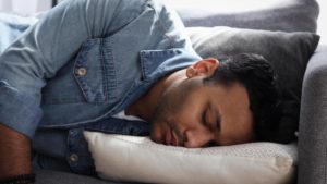 man napping on couch 