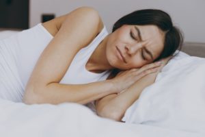 woman sleeping with hands under head