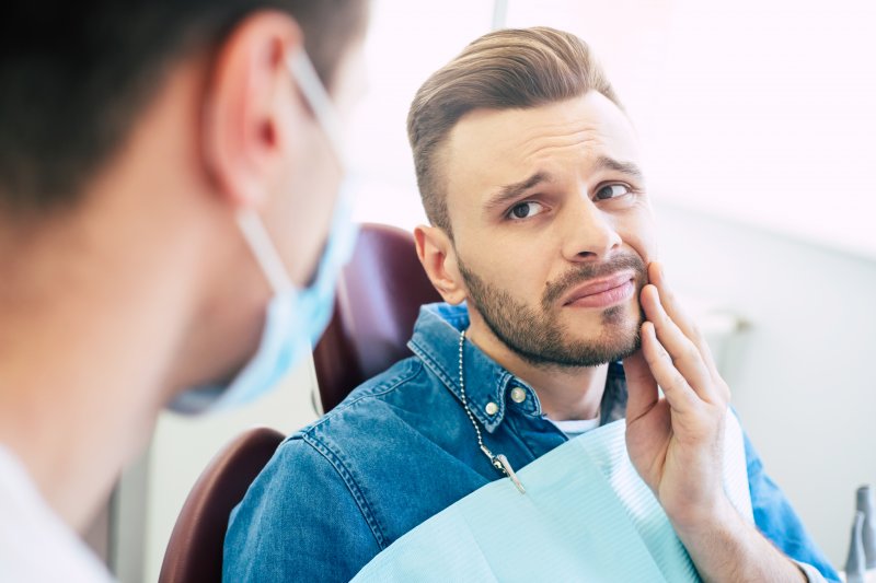 A man experiencing tooth sensitivity