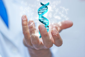Blue DNA spiral floating over scientist's hand