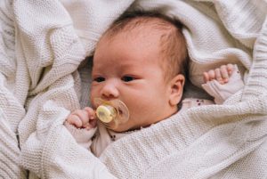Infant sucking on pacifier